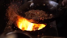 Thai Street Food : Chef Preparing Cooking Fried Pork On Charcoal Stove With Beautiful Flame And Fire, Stir Fry Pork, Slow Motion 4K