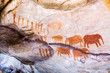 Rock art painting of the bushmen San at Stadsaal, Cederberg, South Africa, showing a group of elephants and men