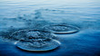 Ripples on sea texture pattern background. Round droplets of water over circles on pool water. Fresh water drop, whirl and splash. Laptop decorative wallpaper. Bright water rings affect the surface.	