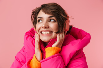 Canvas Print - Portrait of young cheerful woman using headphones and smiling