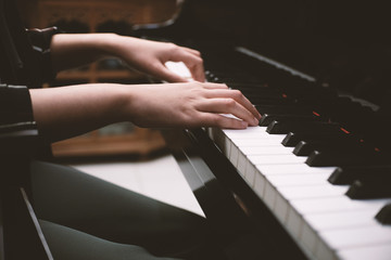 Beautiful woman playing piano, learn to play piano.