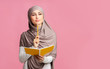 © Prostock-studio - Pensive muslim girl holding notepad and pencil, thinking about something