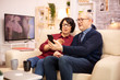 © DC Studio - Old eldelry couple using a smartphone to talk with their family