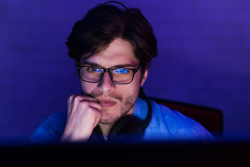 Poster - Serious concentrated developer working on computer at night