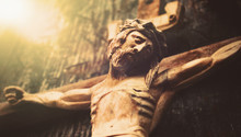 Antique Wooden Statue Of Crucified Jesus Christ Against Dark Wooden Background