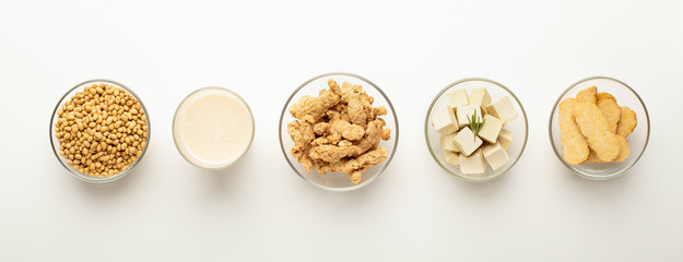 Soybeans, soy milk, soymeat, tofu and tempeh in bowls