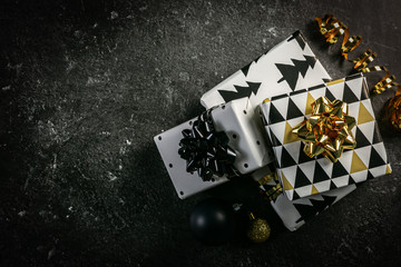 Sticker - Christmas concept - black and golden presents and decorations, marble background, top view