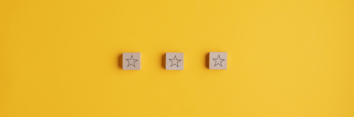 Three wooden blocks with star shape on them placed in a row