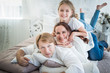 © YouraPechkin - Beautiful positive family mom dad and older daughter and newborn brother in a beautiful and stylish room. Perfect family concept. Advertising concept