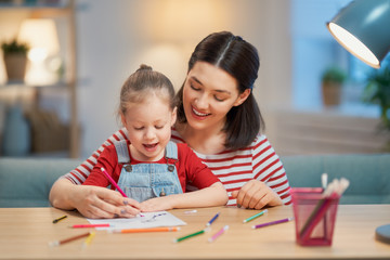 Wall Mural - Girl doing homework with mother