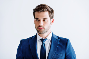 handsome businessman in blue suit looking away isolated on white