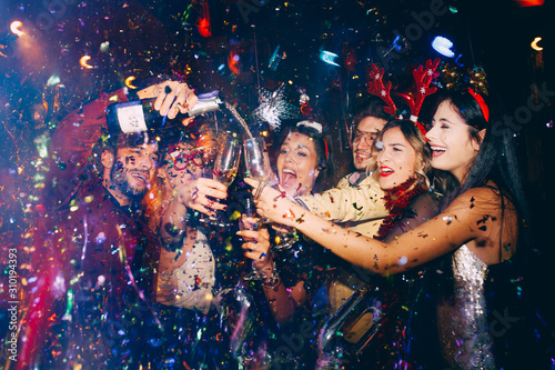 Cuadros en Lienzo Group of friends at club having fun. New year's party
