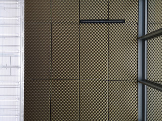Poster - Abstract modern architecture background. Underside view of industrial or office building interior fragment. Ceiling consisting of metal panels with grid structure and windows with steel framework.