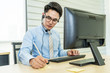 © TeTe Song - Call center, Service desk consultant talking on hands-free phone,  Portrait of Young call center employee taking orders writing on the paper at workplace