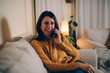 © cherryandbees - woman sitting sofa at home talking on mobile phone