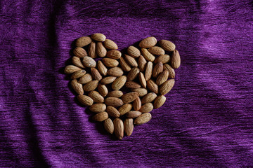 HEALTHY ALMOND IN PURPLE BACKGROUND