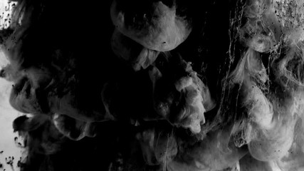 Slow motion exploding tubers of grey smoke on white background