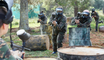 Wall Mural - concentrated teams facing on battlefield in outdoor paintball arena