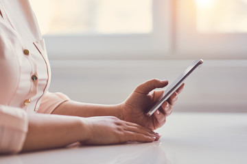 Wall Mural - woman using mobile phone while sitting in office