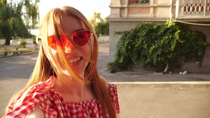 Poster - Beautiful young woman taking selfie outdoors on sunny day. Slow motion effect