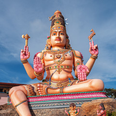 Wall Mural - Giant Colorful God Shiva sculpture in front of a hindu temple, Sri Lanka