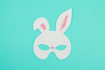 Wall Mural - Top view of symbol Happy Easter holiday background concept. Flat lay accessory with costume bunny mask on blue pastel paper. Copy space for design