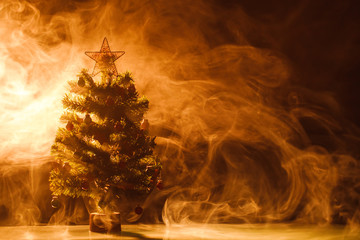 Christmas tree in ice fog, orange background