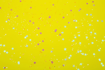 Poster - Holographic stars and silver sparkles on bright yellow background. Festive backdrop for your projects.