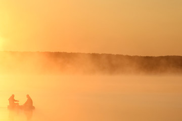 fisherman on the river in the fog in the park on the nature