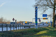 germany, road toll, blue pillar, truck toll station on green gras, traffic signs in the background, blue sky, winter sun, toll collect, maut