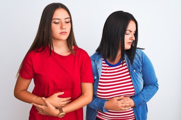 Sticker - Young beautiful women wearing casual clothes standing over isolated white background with hand on stomach because indigestion, painful illness feeling unwell. Ache concept.