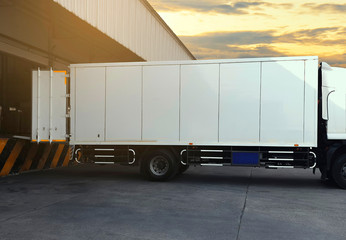 Wall Mural - Cargo Container Trucks Parked Loading Dock at Distribution Warehouse. Shipping Trucks. Lorry. Cargo Freight Trucks Transport Logistics.