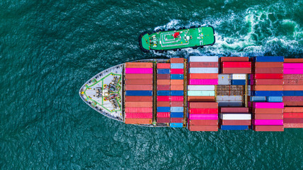 Container ship carrying container for business logistic freight import and export, Aerial view container cargo ship arriving in industrial port or commercial port.