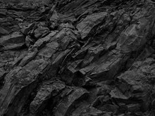 Black White Rock Background. Dark Gray Stone Texture.  Mountain Surface Close-up. Distressed, сracked, Collapsed, Crumbled, Broken. 