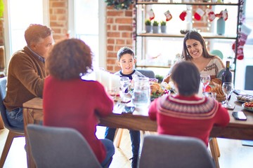 Wall Mural - Beautiful family smiling happy and confident. Eating roasted turkey celebrating christmas at home