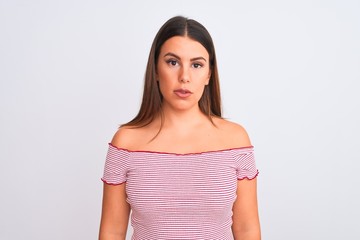 Sticker - Portrait of beautiful young woman standing over isolated white background Relaxed with serious expression on face. Simple and natural looking at the camera.