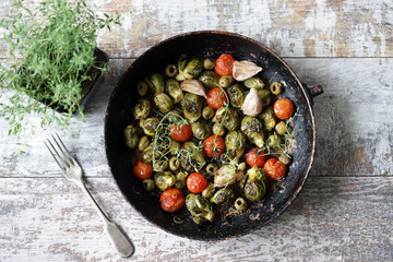 Wall Mural - Brussels sprouts with vegetables and herbs in a pan. Cooking Brussels sprouts. Vega food. Selective focus.