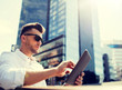 © Syda Productions - business, education, technology, communication and people concept - man in sunglasses with tablet pc computer sitting on city street bench