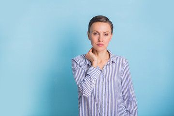 Wall Mural - Portrait of a smart and beautiful young woman over light blue background wearing casual shirt and jeans