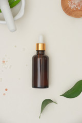 Wall Mural - spa concept with, massage salt in spoon and bottles of essential oil with small leave