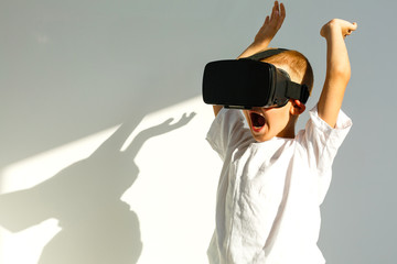 Children experiencing virtual reality isolated on white background. Surprised little boy looking in VR glasses.