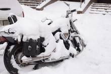 Winter In Russia. Abandoned Motorcycle Covered With A Thick Layer Of Snow