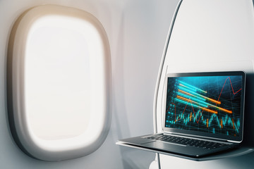 Wall Mural - Laptop closeup inside airplane with forex graph on screen. Financial market trading concept. 3d rendering.