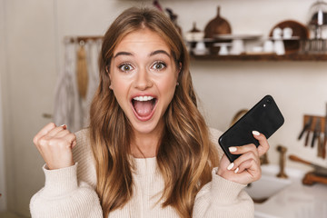 Poster - Image closeup of woman making winner gesture and using cellphone