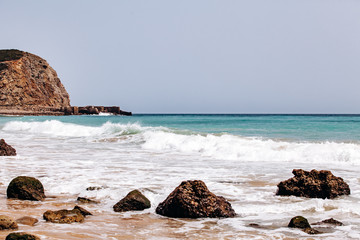 Wall Mural - Beautiful view of the sea waves from the rocks in algarve, Portugal