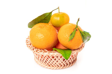 Wall Mural - tangerines  with leaves in a beautiful basket. organic ripe mandarins