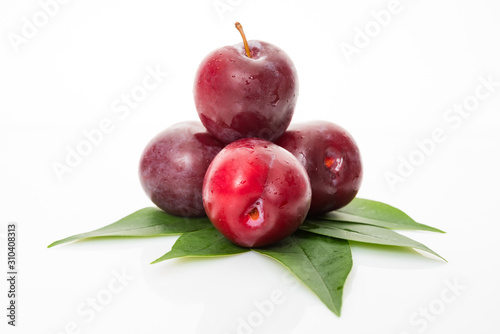 Fotografía plums with plum leaves isolated on a white background