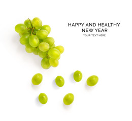 Creative happy and healthy new year card made of green grapes on the white background.  Green grapes happy new year, top view, festive greeting card.