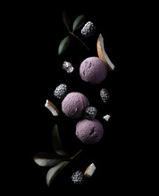Flying Berry Balls Ice Cream With Blackberries And Coconut Slices On Black Background