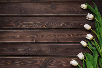 Wall Mural - White tulips on a brown wooden table. Blank greeting card for Valentine's day